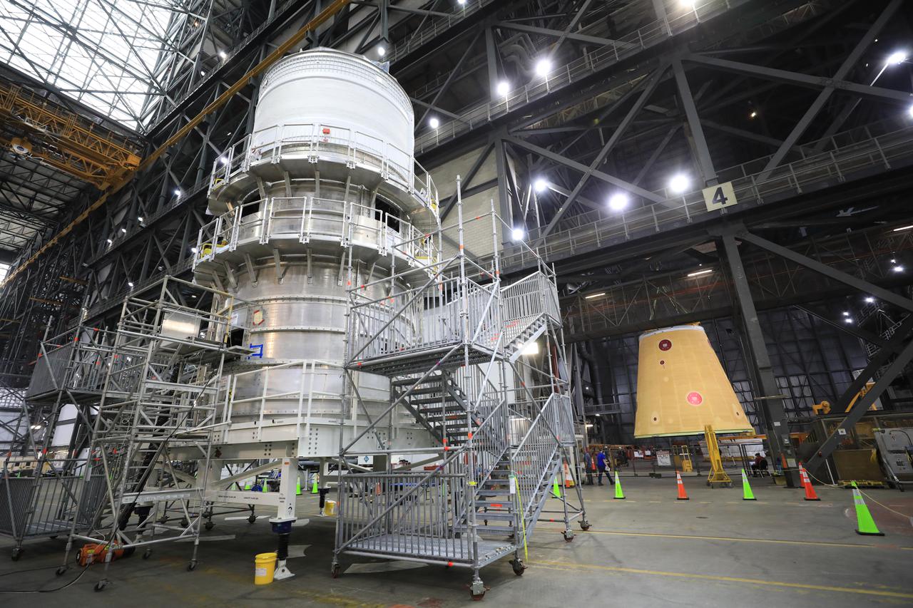 The launch vehicle stage adapter for the Artemis I mission is lifted into place atop the already assembled pieces of the Space Launch System rocket.