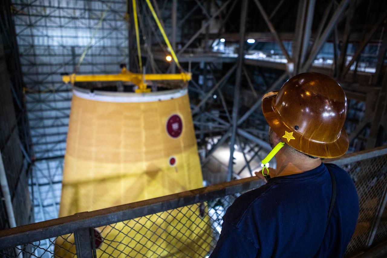 Teams with NASA’s Exploration Ground Systems and contractor Jacobs integrate the launch vehicle stage adapter (LVSA) for NASA’s Space Launch System (SLS) rocket with the massive SLS core stage on the mobile launcher in the agency’s Vehicle Assembly Building (VAB) at NASA’s Kennedy Space Center in Florida on June 22, 2021. Engineers used one of five VAB cranes to lift the adapter almost 250-feet in the air and then slowly lower it on to the core stage. The LVSA arrived at Kennedy from the agency’s Marshall Space Flight Center in Huntsville, Alabama, in July 2020 and has remained in the VAB for processing. During integration, known as “stacking,” the LVSA is bolted to the forward skirt of the core stage, connecting the core stage and the interim cryogenic propulsion stage in preparation for the first flight of the rocket and the Orion spacecraft during Artemis I. The ICPS’s RL10 engine will fit down inside the LVSA, which protects the engine during launch. The first in a series of increasingly complex missions, Artemis I will test SLS and the Orion spacecraft as an integrated system prior to crewed flights in which NASA will land the first woman and person of color on the Moon.