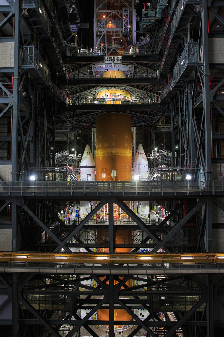 Seen here is the launch vehicle stage adapter (LVSA) for NASA’s Space Launch System (SLS) rocket atop the massive SLS core stage on the mobile launcher in the agency’s Vehicle Assembly Building (VAB) at NASA’s Kennedy Space Center in Florida on June 24, 2021. Teams with NASA’s Exploration Ground Systems and contractor Jacobs used one of five VAB cranes to lift the adapter almost 250-feet in the air and then slowly lower it on to the core stage earlier this week. The LVSA arrived at Kennedy from the agency’s Marshall Space Flight Center in Huntsville, Alabama, in July 2020 and has remained in the VAB for processing. During integration, known as “stacking,” the LVSA is bolted to the forward skirt of the core stage, connecting the core stage and the interim cryogenic propulsion stage in preparation for the first flight of the rocket and the Orion spacecraft during Artemis I. The ICPS’s RL10 engine will fit down inside the LVSA, which protects the engine during launch. The first in a series of increasingly complex missions, Artemis I will test SLS and the Orion spacecraft as an integrated system prior to crewed flights in which NASA will land the first woman and person of color on the Moon.
