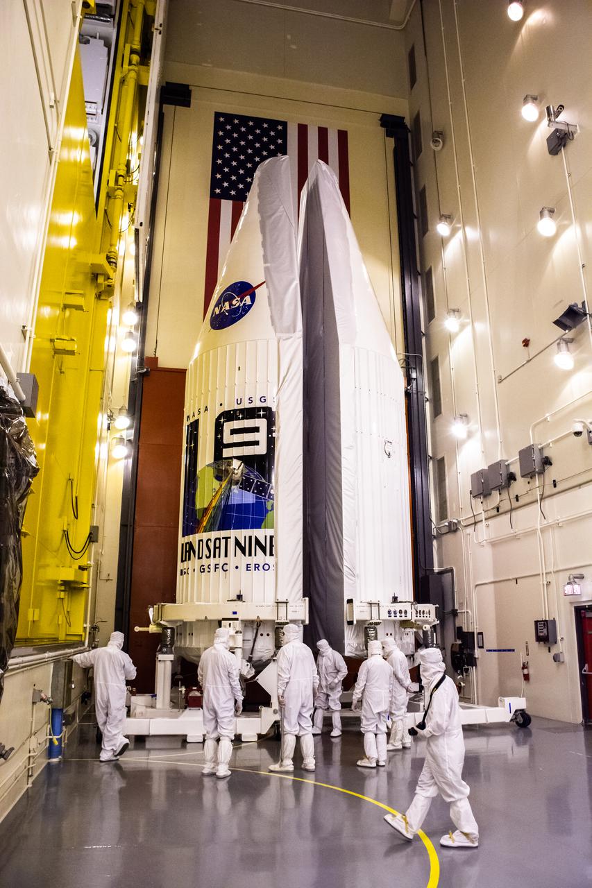 Inside the Integrated Processing Facility at Vandenberg Space Force Base in California, United Launch Alliance (ULA) technicians remove the contamination barrier from the two ULA Atlas V rocket payload fairings for NASA’s Landsat 9 satellite on June 23, 2021. The fairings will encapsulate the satellite for its launch atop the Atlas V from Vandenberg in September 2021. The launch is being managed by NASA’s Launch Services Program based at Kennedy Space Center in Florida. Landsat 9 will continue the nearly 50-year legacy of previous Landsat missions. It will monitor key natural and economic resources from orbit. Landsat 9 is managed by the agency’s Goddard Space Flight Center in Greenbelt, Maryland. It will carry two instruments: the Operational Land Imager 2, which collects images of Earth’s landscapes in visible, near-infrared and shortwave infrared light, and the Thermal Infrared Sensor 2, which measures the temperature of land surfaces. Like its predecessors, Landsat 9 is a joint mission between NASA and the U.S. Geological Survey.