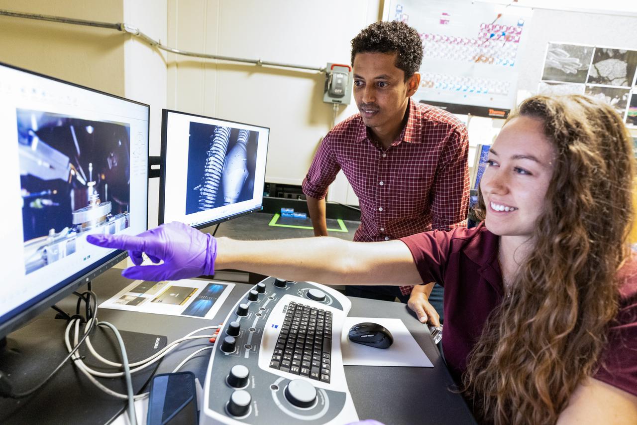 Chemists Misle Tessema (left) and Macy Mullen (right) discuss scanning electron microscope operations inside NASA Engineering’s Analytical Laboratories at Kennedy Space Center in Florida on July 7, 2021. One of seven branches in the NASA Laboratories, Development, and Testing Division, the Analytical Laboratories branch provides microscopic imagery and analysis through the use of a wide variety of microscopic techniques to identify contaminants and other urgent problems associated with aerospace flight hardware, ground support equipment, and related facilities. 