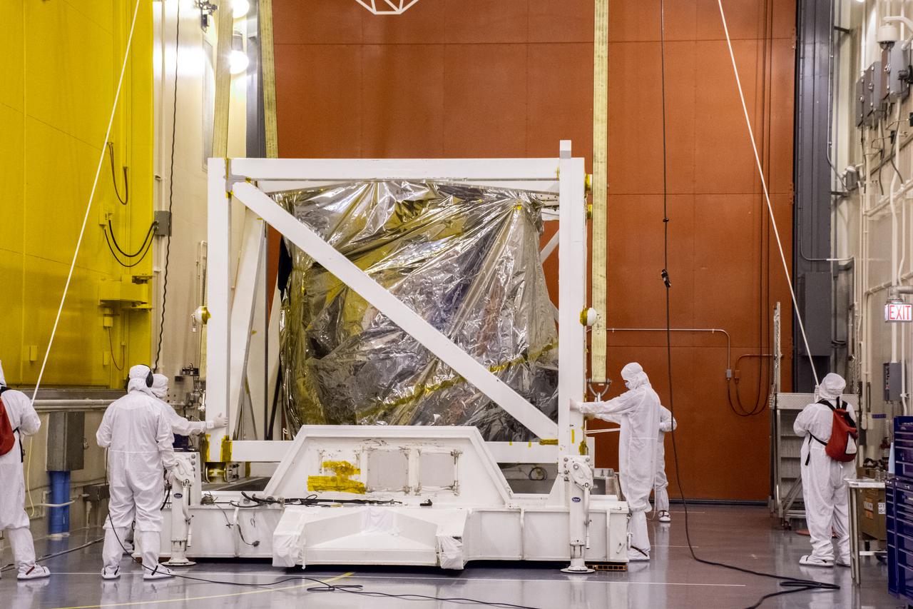 Inside the Integrated Processing Facility at Vandenberg Space Force Base in California, technicians prepare to lift the Landsat 9 spacecraft up from the base of its protective container on July 8, 2021. Landsat 9 is being prepared for its launch atop the ULA Atlas V from Vandenberg in September 2021. The launch is being managed by NASA’s Launch Services Program based at Kennedy Space Center in Florida. Landsat 9 will continue the nearly 50-year legacy of previous Landsat missions. It will monitor key natural and economic resources from orbit. Landsat 9 is managed by the agency’s Goddard Space Flight Center in Greenbelt, Maryland. It will carry two instruments: the Operational Land Imager 2, which collects images of Earth’s landscapes in visible, near-infrared and shortwave infrared light, and the Thermal Infrared Sensor 2, which measures the temperature of land surfaces. Like its predecessors, Landsat 9 is a joint mission between NASA and the U.S. Geological Survey.