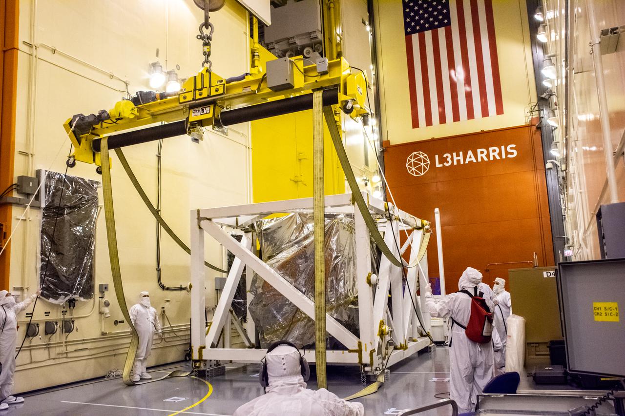 Technicians assist as a crane lowers the Landsat 9 spacecraft secured in its protective stand on the floor of the Integrated Processing Facility at Vandenberg Space Force Base in California, on July 8, 2021. Landsat 9 is being prepared for its launch atop the ULA Atlas V from Vandenberg in September 2021. The launch is being managed by NASA’s Launch Services Program based at Kennedy Space Center in Florida. Landsat 9 will continue the nearly 50-year legacy of previous Landsat missions. It will monitor key natural and economic resources from orbit. Landsat 9 is managed by the agency’s Goddard Space Flight Center in Greenbelt, Maryland. It will carry two instruments: the Operational Land Imager 2, which collects images of Earth’s landscapes in visible, near-infrared and shortwave infrared light, and the Thermal Infrared Sensor 2, which measures the temperature of land surfaces. Like its predecessors, Landsat 9 is a joint mission between NASA and the U.S. Geological Survey.