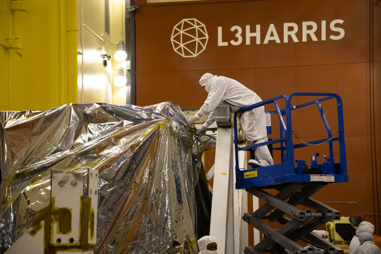 The Landsat 9 spacecraft (observatory) undergoes breakover operations inside the Integrated Processing Facility at Vandenberg Space Force Base in California. 