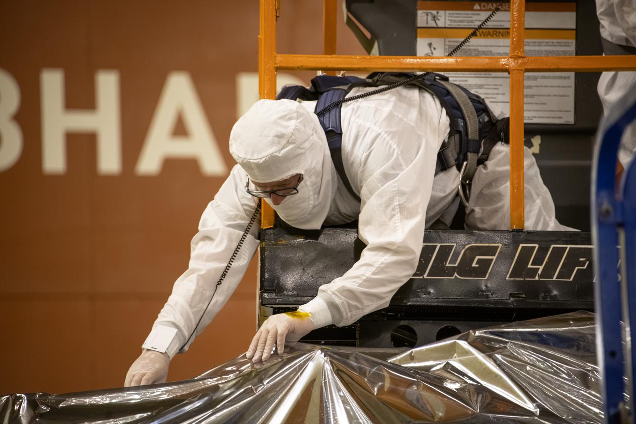 The Landsat 9 spacecraft (observatory) undergoes breakover operations inside the Integrated Processing Facility at Vandenberg Space Force Base in California. 