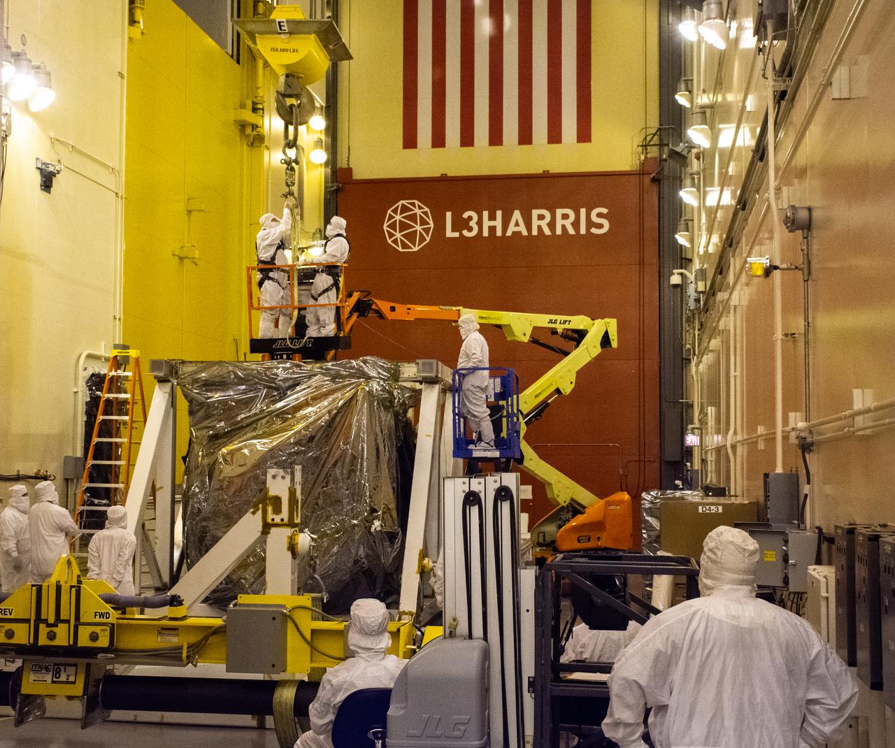 The Landsat 9 spacecraft (observatory) undergoes breakover operations inside the Integrated Processing Facility at Vandenberg Space Force Base in California. 