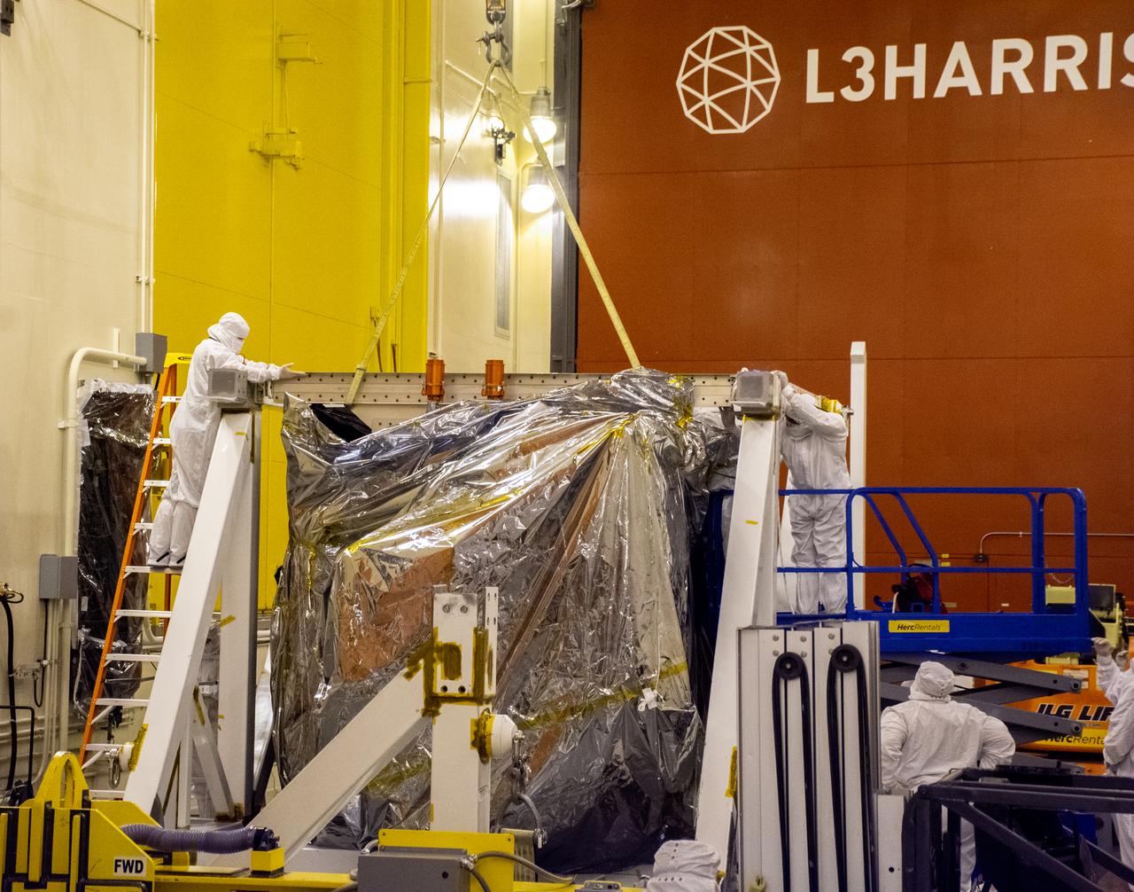 The Landsat 9 spacecraft (observatory) undergoes breakover operations inside the Integrated Processing Facility at Vandenberg Space Force Base in California. 