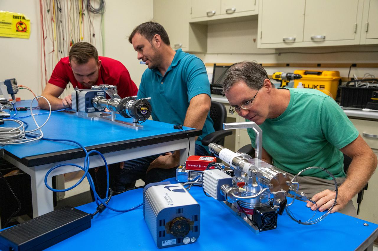 From left to right, Kennedy Space Center employees Stefan Tomovic, Beau Peacock, and Chris Bond work with MSolo (Mass Spectrometer Observing Lunar Operations) test hardware at the Florida spaceport on July 13, 2021. MSolo is a commercial off-the-shelf mass spectrometer modified by the team at Kennedy to work in the harsh, rigorous conditions of the Moon. MSolo is heading to the Moon on four of NASA’s Commercial Lunar Payload Services initiative or CLPS missions, including the Polar Resources Ice Mining Experiment-1 (PRIME-1) and NASA’s Volatiles Investigating Polar Exploration Rover, or VIPER. Kennedy is working in partnership with INFICON, of Syracuse, New York, to develop the mass spectrometer.