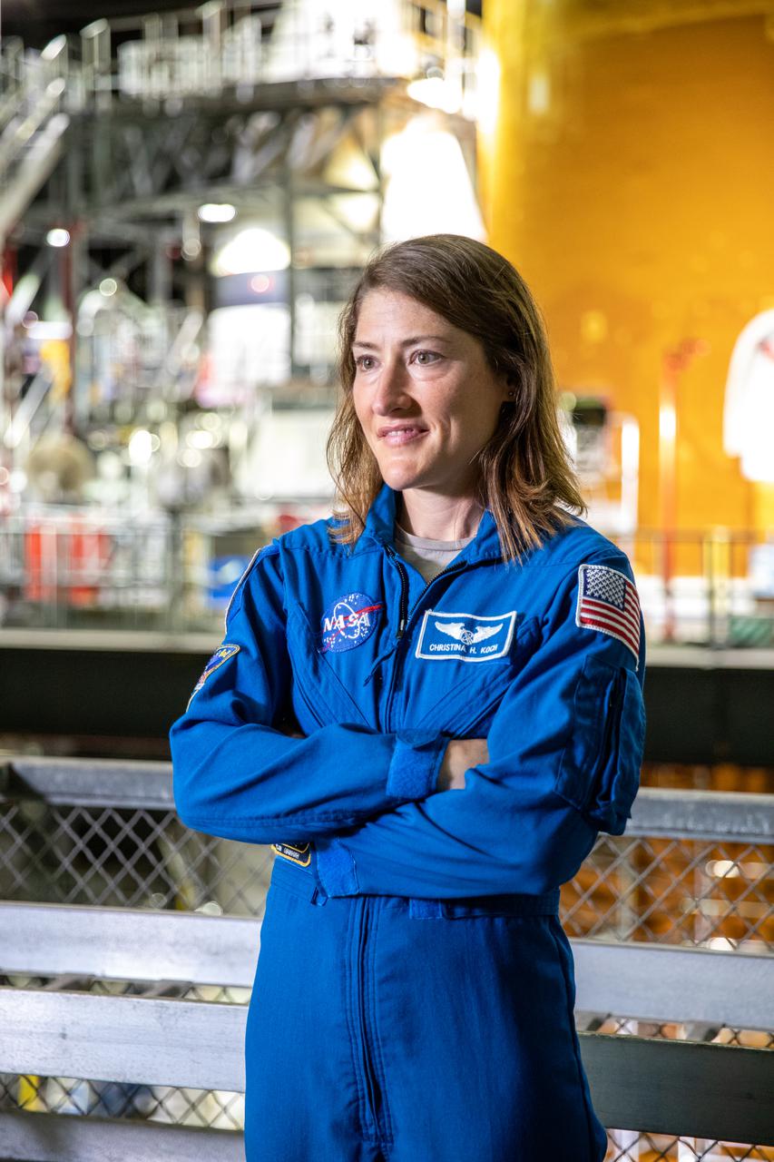 NASA astronaut Christina Koch stands inside Kennedy Space Center’s Vehicle Assembly Building on July 14, 2021, in front of the agency’s Space Launch System (SLS) rocket that will power the Orion spacecraft on the Artemis I mission later this year. Artemis I will be an uncrewed flight test of Orion and SLS as an integrated system ahead of missions with astronauts. Under Artemis, NASA aims to land the first woman and first person of color on the Moon and establish a long-lasting presence on and around the Moon while preparing for human missions to Mars.
