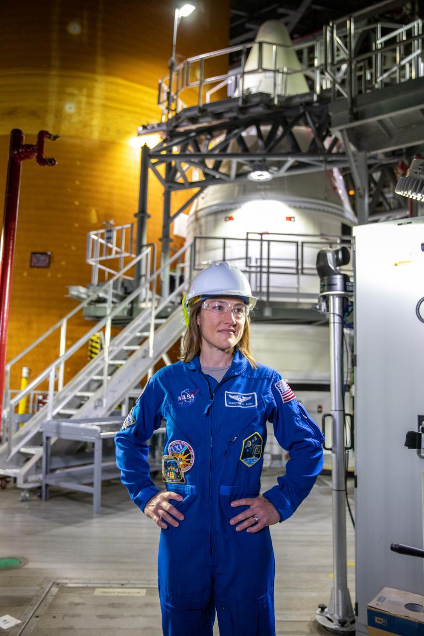 NASA astronaut Christina Koch stands inside Kennedy Space Center’s Vehicle Assembly Building on July 14, 2021, in front of the agency’s Space Launch System (SLS) rocket that will power the Orion spacecraft on the Artemis I mission later this year. Artemis I will be an uncrewed flight test of Orion and SLS as an integrated system ahead of missions with astronauts. Under Artemis, NASA aims to land the first woman and first person of color on the Moon and establish a long-lasting presence on and around the Moon while preparing for human missions to Mars.
