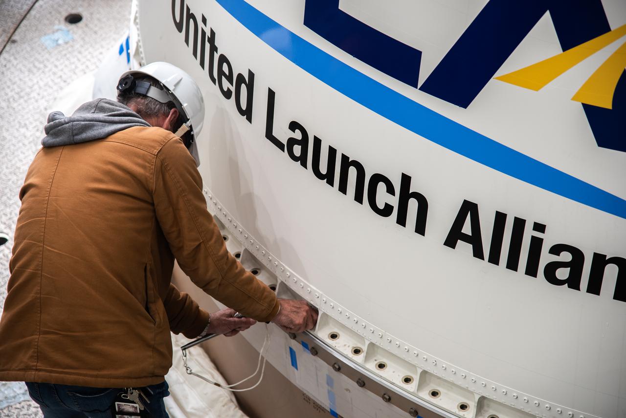 Inside the Vertical Integration Facility at Space Launch Complex 3 at Vandenberg Space Source Base in California, workers help secure the interstage and assembly second stage adapters to the Centaur second stage of the United Launch Alliance Atlas V rocket for NASA’s Landsat 9 mission on July 14, 2021. Landsat 9 will launch atop the Atlas V rocket from Vandenberg in September 2021. The launch is being managed by NASA’s Launch Services Program based at Kennedy Space Center, America’s multiuser spaceport. The Landsat 9 satellite will continue the nearly 50-year legacy of previous Landsat missions. It will monitor key natural and economic resources from orbit. Landsat 9 is managed by the agency’s Goddard Space Flight Center in Greenbelt, Maryland. The satellite will carry two instruments: the Operational Land Imager 2, which collects images of Earth’s landscapes in visible, near infrared and shortwave infrared light, and the Thermal Infrared Sensor 2, which measures the temperature of land surfaces. Like its predecessors, Landsat 9 is a joint mission between NASA and the U.S. Geological Survey.
