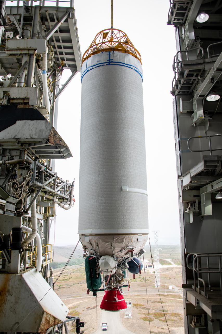 The United Launch Alliance Centaur second stage for NASA’s Landsat 9 mission seems suspended in midair in this view from inside the Vertical Integration Facility at Space Launch Complex 3 at Vandenberg Space Force Base in California, on July 15, 2021. The Centaur will be moved into the integration facility and attached to the top of the Atlas V booster. The Landsat 9  mission will launch atop the Atlas V rocket from Vandenberg in September 2021. The launch is being managed by NASA’s Launch Services Program based at Kennedy Space Center, America’s multiuser spaceport. The Landsat 9 satellite will continue the nearly 50-year legacy of previous Landsat missions. It will monitor key natural and economic resources from orbit. Landsat 9 is managed by the agency’s Goddard Space Flight Center in Greenbelt, Maryland. The satellite will carry two instruments: the Operational Land Imager 2, which collects images of Earth’s landscapes in visible, near infrared and shortwave infrared light, and the Thermal Infrared Sensor 2, which measures the temperature of land surfaces. Like its predecessors, Landsat 9 is a joint mission between NASA and the U.S. Geological Survey.