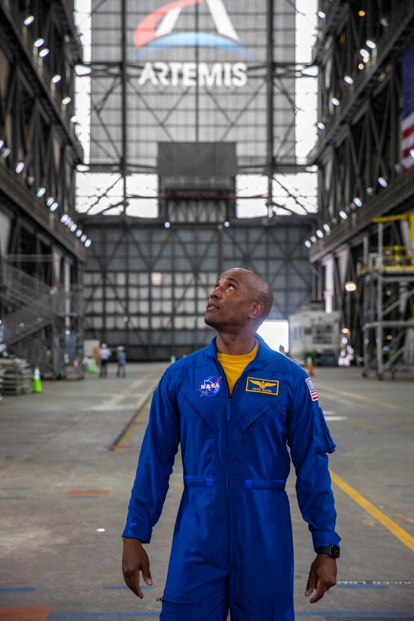 NASA astronaut Victor Glover looks up while inside Kennedy Space Center’s Vehicle Assembly Building on July 15, 2021, on his way to view the agency’s Space Launch System rocket that will power the Orion spacecraft on the Artemis I mission later this year. Artemis I will be a test of Orion and SLS as an integrated system ahead of crewed flights to the Moon. Under Artemis, NASA aims to land the first woman and first person of color on the Moon and establish long-term lunar exploration.