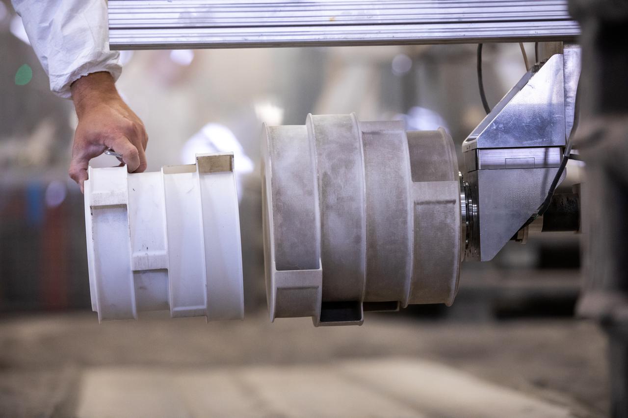 A team at NASA’s Kennedy Space Center in Florida tests small- and medium-sized bucket drums July 16, 2021, in the Granular Mechanics and Regolith Operations Lab’s “big bin” during prototype development for the pilot excavator, a robotic mission designed for lunar operations. The bucket drum excavated lunar regolith simulant. The Swamp Works team leveled and compacted the simulant before excavation as well as measured penetration during the excavator testing. Robotics engineers Jason Schuler and Austin Langton worked inside the bin, teaming up with software engineer Kurt Leucht, who worked just outside of it.