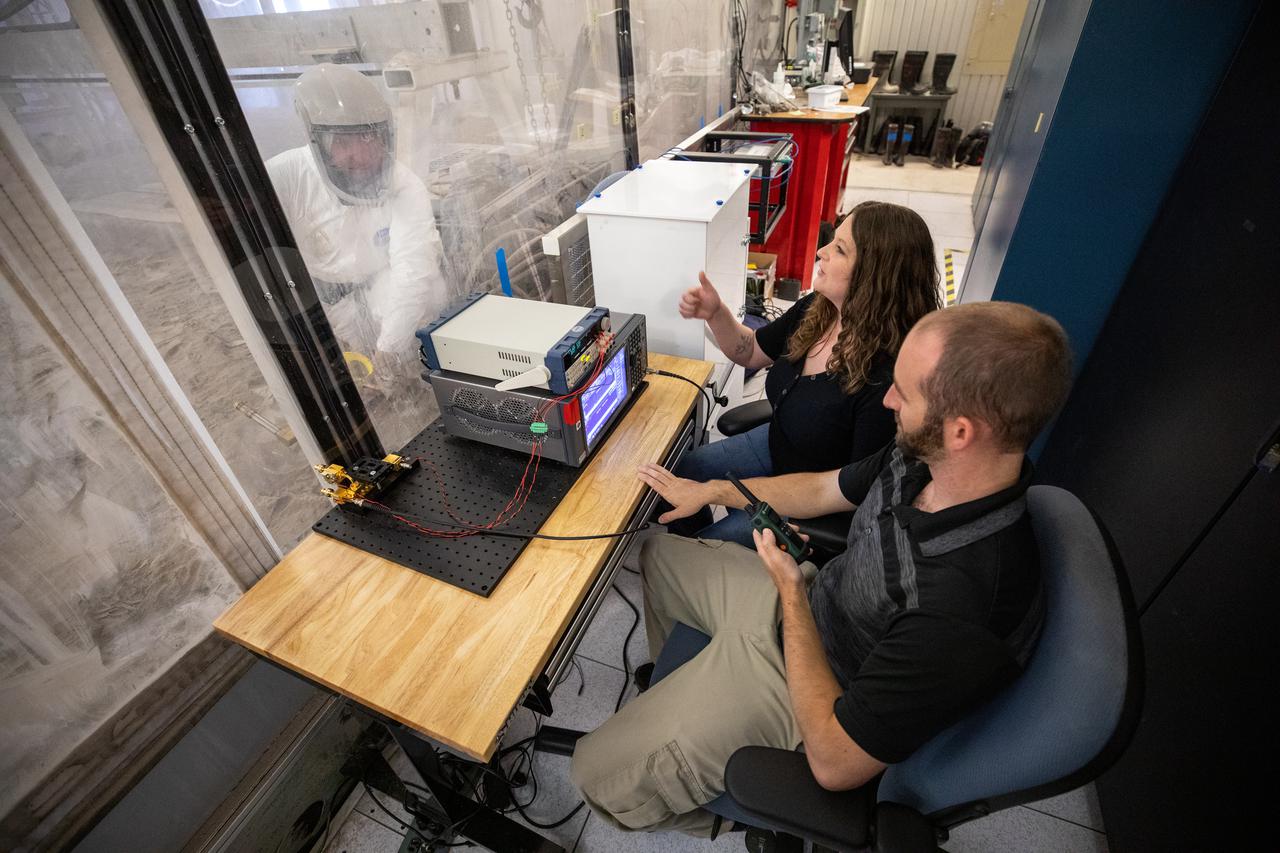 Beverly Kemmerer and Austin Adkins, right, and Austin Langton, perform testing with a Millimeter Wave Doppler Radar at NASA’s Kennedy Space Center’s Granular Mechanics and Regolith Operations Lab on July 16, 2021. The testing at the Florida spaceport is part of a project to identify a suite of instrumentation capable of acquiring a comprehensive set of flight data from a lunar lander. Researchers at NASA will use that data to validate computational models being developed to predict plume surface interaction effects on the Moon.