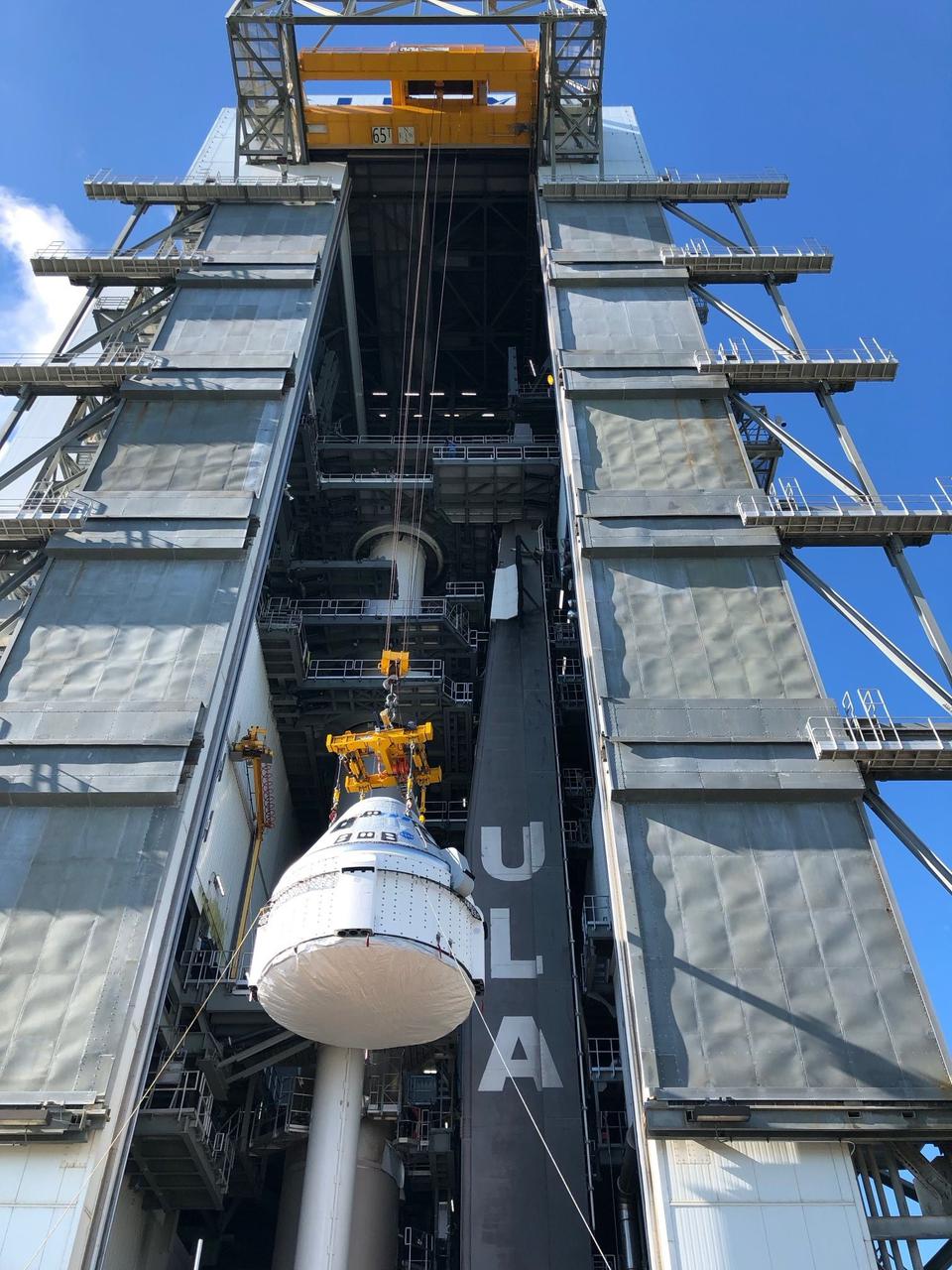 Boeing’s CST-100 Starliner spacecraft is lifted at the Vertical Integration Facility at Space Launch Complex-41 at Florida’s Cape Canaveral Space Force Station on July 17, 2021. Starliner will be secured atop a United Launch Alliance Atlas V rocket for Boeing’s Orbital Flight Test to the International Space Station for NASA’s Commercial Crew Program. The spacecraft rolled out from Boeing’s Commercial Crew and Cargo Processing Facility at NASA’s Kennedy Space Center earlier in the day.