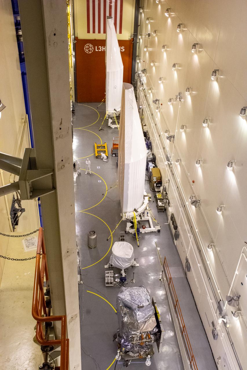 NASA’s Landsat 9 spacecraft, in view in the foreground, is being prepared for its move from the high bay to Cell 3 inside the Integrated Processing Facility at Vandenberg Space Force Base in California, on July 20, 2021. In view in the background are the two halves of the United Launch Alliance payload fairing that will be secured around Landsat 9 to protect it during launch atop the ULA Atlas V rocket. Landsat 9 will launch on the Atlas V rocket from Space Launch Complex 3 at Vandenberg in September 2021. The launch is being managed by NASA’s Launch Services Program based at Kennedy Space Center, America’s multi-user spaceport. The Landsat 9 satellite will continue the nearly 50-year legacy of previous Landsat missions. It will monitor key natural and economic resources from orbit. Landsat 9 is managed by the agency’s Goddard Space Flight Center in Greenbelt, Maryland. The satellite will carry two instruments: the Operational Land Imager 2, which collects images of Earth’s landscapes in visible, near infrared and shortwave infrared light, and the Thermal Infrared Sensor 2, which measures the temperature of land surfaces. Like its predecessors, Landsat 9 is a joint mission between NASA and the U.S. Geological Survey.