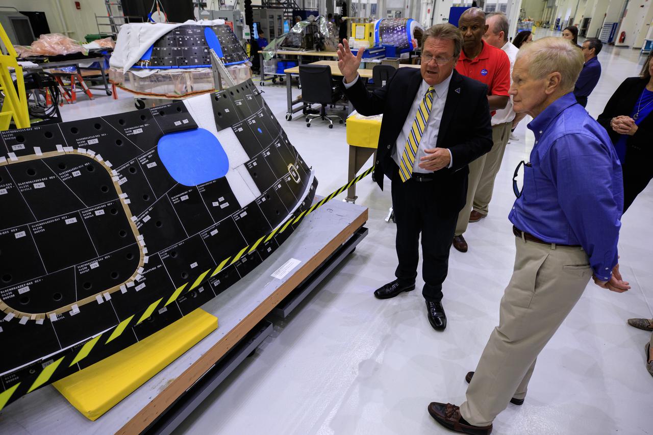 NASA Administrator Bill Nelson, right, tours the Neil Armstrong Operations and Checkout Building during a visit to the agency’s Kennedy Space Center in Florida on July 27, 2021. In this photo, Jules Schneider, Lockheed Martin director of Orion Assembly, Test, and Launch Operations at Kennedy, is showing Nelson the thermal protection tiles on the forward bay cover for the Artemis II crew module. Behind Schneider is Kennedy Deputy Director Kelvin Manning. Artemis II is the first crewed mission in a series of missions to the Moon and Mars. The mission will test the Space Launch System rocket and Orion spacecraft as an integrated system with astronauts on board. Through Artemis, NASA will land the first woman and first person of color on the lunar surface, as well as establish a sustainable presence on and around the Moon.