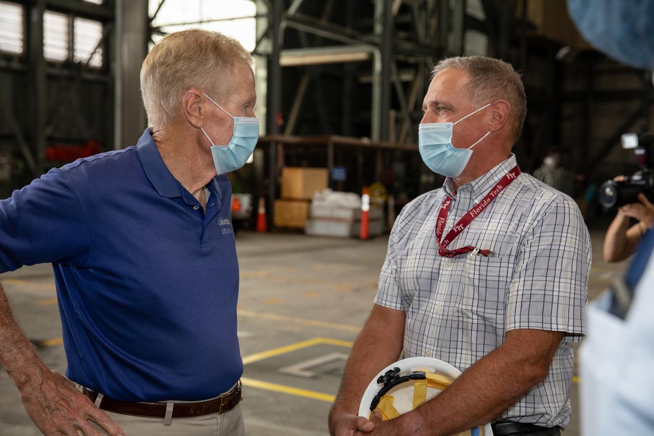 NASA Administrator Bill Nelson, left, tours the Vehicle Assembly Building (VAB) during a visit to the agency’s Kennedy Space Center in Florida on July 28, 2021. To his right is Mark Nappi, Boeing integrated product team leader for Space Launch System (SLS) core stage 1. While inside the VAB, Nelson had the opportunity to view the SLS rocket as preparations for the Artemis I launch continue. The first in an increasingly complex set of missions, Artemis I will test SLS and Orion as an integrated system prior to crewed flights to the Moon. Through Artemis, NASA will land the first woman and first person of color on the lunar surface, as well as establish a sustainable presence on and around the Moon.