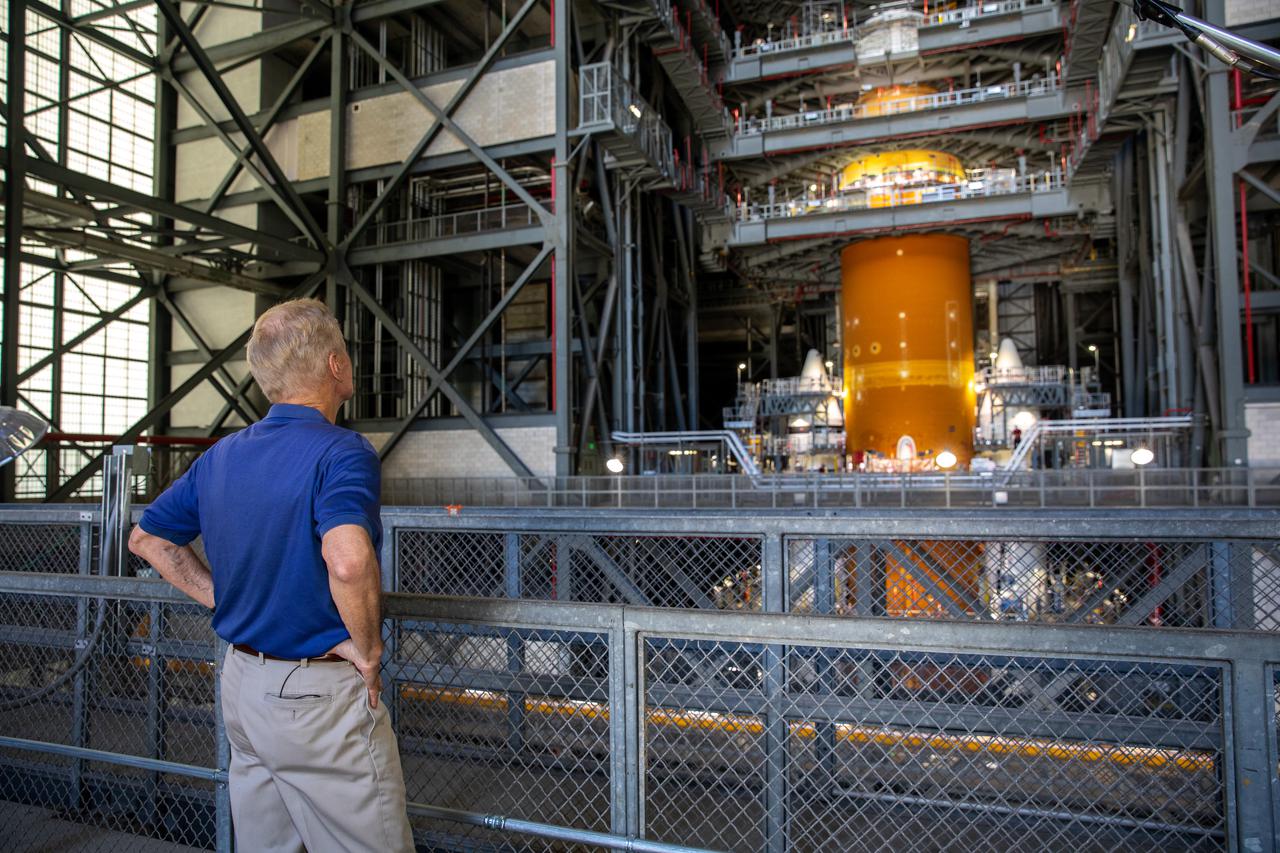 NASA Administrator Bill Nelson views the Space Launch System (SLS) rocket inside the Vehicle Assembly Building during a tour and visit to the agency’s Kennedy Space Center in Florida on July 28, 2021, as preparations for the Artemis I launch continue. The first in an increasingly complex set of missions, Artemis I will test SLS and Orion as an integrated system prior to crewed flights to the Moon. Through Artemis, NASA will land the first woman and first person of color on the lunar surface, as well as establish a sustainable presence on and around the Moon.