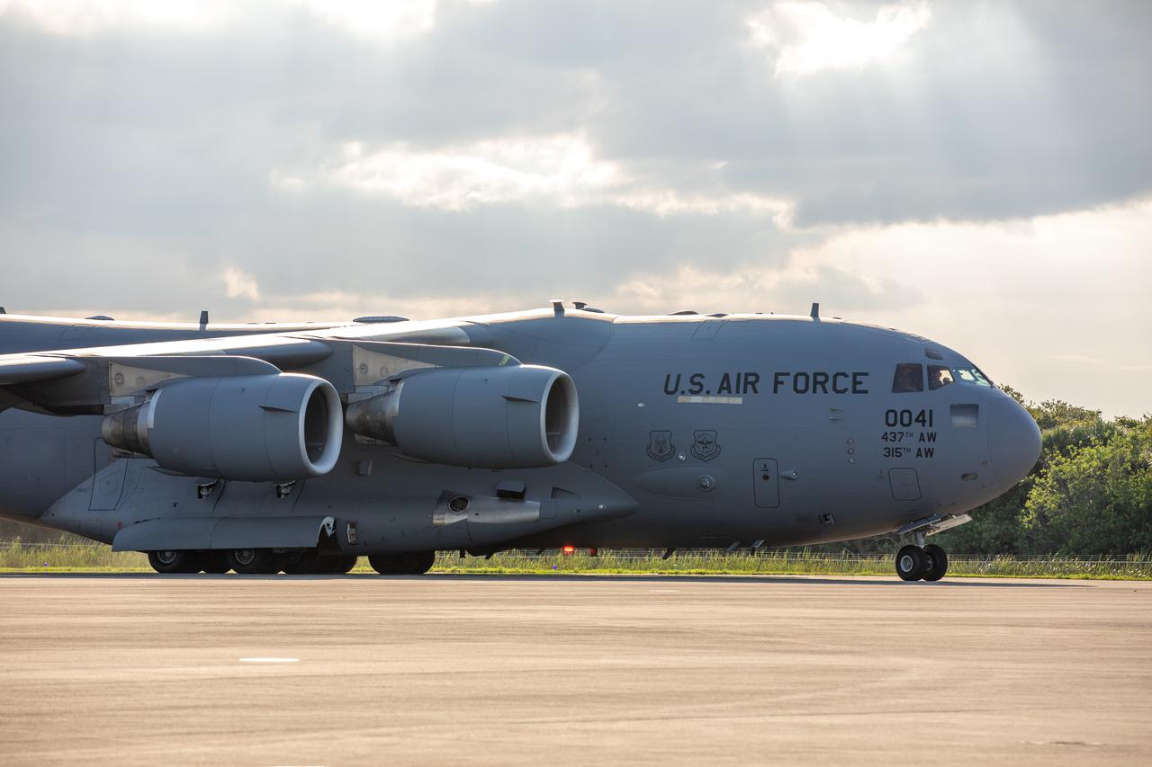 A United States Air Force C-17 cargo plane, stationed out of Charleston Air Force Base in South Carolina, holding NASA's Lucy spacecraft lands on the runway of the Launch and Landing Facility at Kennedy Space Center in Florida on July 30, 2021. From there, the Lucy spacecraft will move to the Astrotech Space Operations payload processing facility in nearby Titusville, Florida, before its scheduled launch on a United Launch Alliance (ULA) Atlas V rocket from Cape Canaveral Space Force Station on October 16, 2021. The Lucy mission will be the first space mission to explore a diverse population of small bodies known as the Jupiter Trojan asteroids. The launch is being managed by NASA's Launch Services Program based at Kennedy, America's multi-user spaceport.