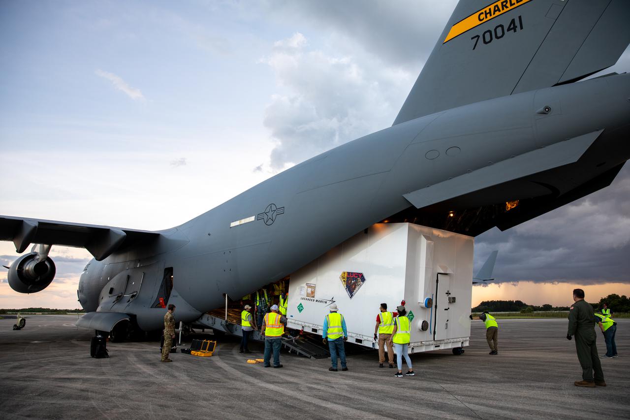 NASA’s Lucy spacecraft arrives by cargo plane and is unloaded on the runway of the Launch and Landing Facility at Kennedy Space Center in Florida on July 30, 2021. From there, the Lucy spacecraft will move to the Astrotech Space Operations - Florida payload processing facility in nearby Titusville, Florida, before its scheduled launch on a United Launch Alliance (ULA) Atlas V rocket from Cape Canaveral Space Force Station on October 16, 2021. The Lucy mission will be the first space mission to explore a diverse population of small bodies known as the Jupiter Trojan asteroids. The launch is being managed by NASA’s Launch Services Program based at Kennedy, America’s premier multi-user spaceport.