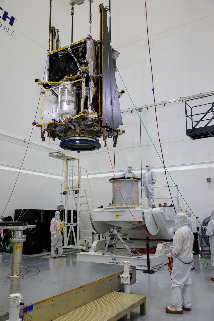 Workers inside the Astrotech Space Operations Facility in Titusville, Florida, monitor the progress as NASA’s Lucy spacecraft is lifted by crane for its transfer to a rotation stand on Aug. 4, 2021. Lucy is scheduled to launch no earlier than Saturday, Oct. 16, on a United Launch Alliance Atlas V 401 rocket from Launch Pad 41 at Cape Canaveral Space Force Station. NASA’s Launch Services Program based at Kennedy Space Center is managing the launch. Over its 12-year primary mission, Lucy will explore a record-breaking number of asteroids, flying by one asteroid in the solar system’s main belt and seven Trojan asteroids. Additionally, Lucy’s path will circle back to Earth three times for gravity assists, making it the first spacecraft ever to return to the vicinity of Earth from the outer solar system. 