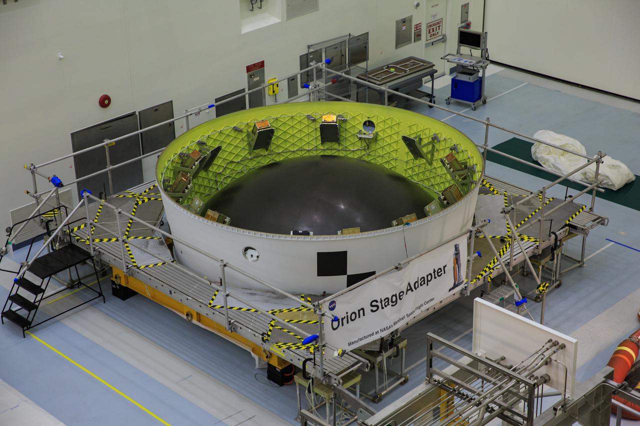 Small satellites, called CubeSats, are shown secured inside NASA’s Orion stage adapter at NASA’s Kennedy Space Center in Florida on Aug. 5, 2021. Technicians from Exploration Ground Systems and Jacobs teams are working with developers of the shoebox-sized secondary payloads as they undergo final processing. The ring-shaped stage adapter will be connected to the Space Launch System’s Interim Cryogenic Propulsion Stage, and the Orion spacecraft will be secured on top. The CubeSats will conduct a variety of science experiments and technology demonstrations that will expand our knowledge of the lunar surface during the Artemis I mission.