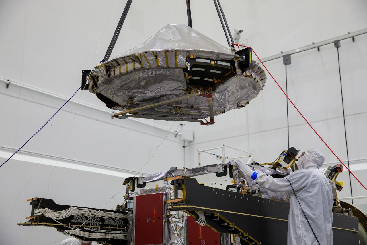 Workers assist as a crane lowers the high gain antenna for installation on NASA’s Lucy spacecraft inside the Astrotech Space Operations Facility in Titusville, Florida, on Aug. 6, 2021. Lucy is scheduled to launch no earlier than Saturday, Oct. 16, on a United Launch Alliance Atlas V 401 rocket from Launch Pad 41 at Cape Canaveral Space Force Station. NASA’s Launch Services Program based at Kennedy Space Center is managing the launch. Over its 12-year primary mission, Lucy will explore a record-breaking number of asteroids, flying by one asteroid in the solar system’s main belt and seven Trojan asteroids. Additionally, Lucy’s path will circle back to Earth three times for gravity assists, making it the first spacecraft ever to return to the vicinity of Earth from the outer solar system. 