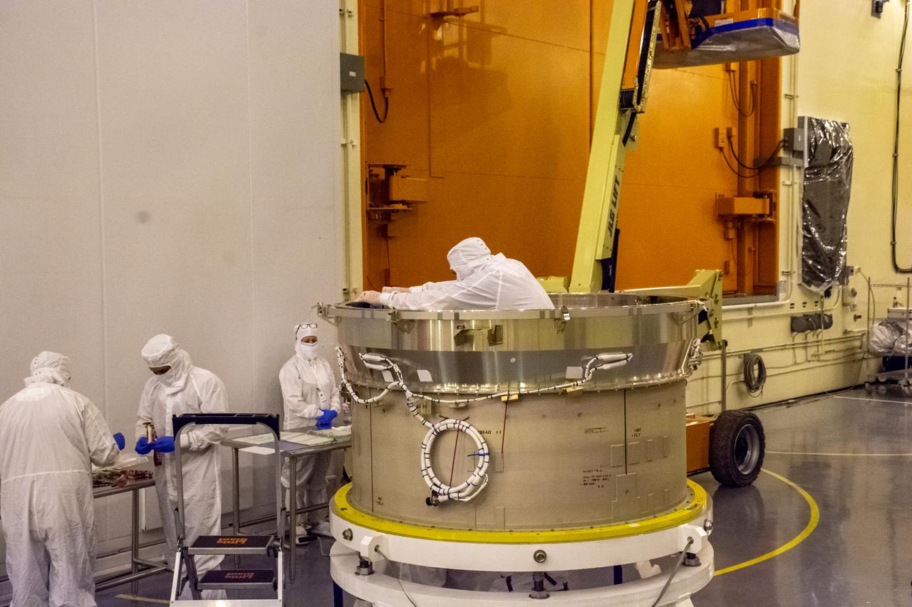On Aug. 9, 2021, technicians ready the payload adapter (PMA) for mating operations in preparation for NASA’s Landsat 9 mission at Vandenberg Space Force Base in California. On one end, the PMA will attach to the second stage of a United Launch Alliance Atlas V rocket. On the other, it will attach to the evolved expendable vehicle secondary payload adapter – the piece of flight hardware that connects the spacecraft to the PMA. Landsat 9 will launch on the Atlas V from Space Launch Complex 3 at Vandenberg in September 2021. The launch is being managed by NASA’s Launch Services Program based at Kennedy Space Center, America’s multi-user spaceport. The Landsat 9 satellite will continue the nearly 50-year legacy of previous Landsat missions. It will monitor key natural and economic resources from orbit. Landsat 9 is managed by the agency’s Goddard Space Flight Center in Greenbelt, Maryland. The satellite will carry two instruments: the Operational Land Imager 2, which collects images of Earth’s landscapes in visible, near infrared and shortwave infrared light, and the Thermal Infrared Sensor 2, which measures the temperature of land surfaces. Like its predecessors, Landsat 9 is a joint mission between NASA and the U.S. Geological Survey.