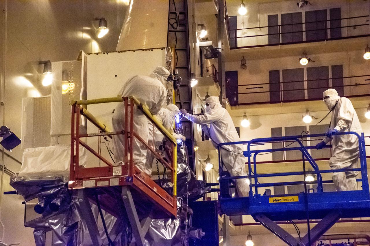 The Landsat 9 instrument cover is removed from the spacecraft inside the Integrated Processing Facility (IPF) at Vandenberg Space Force Base in California.