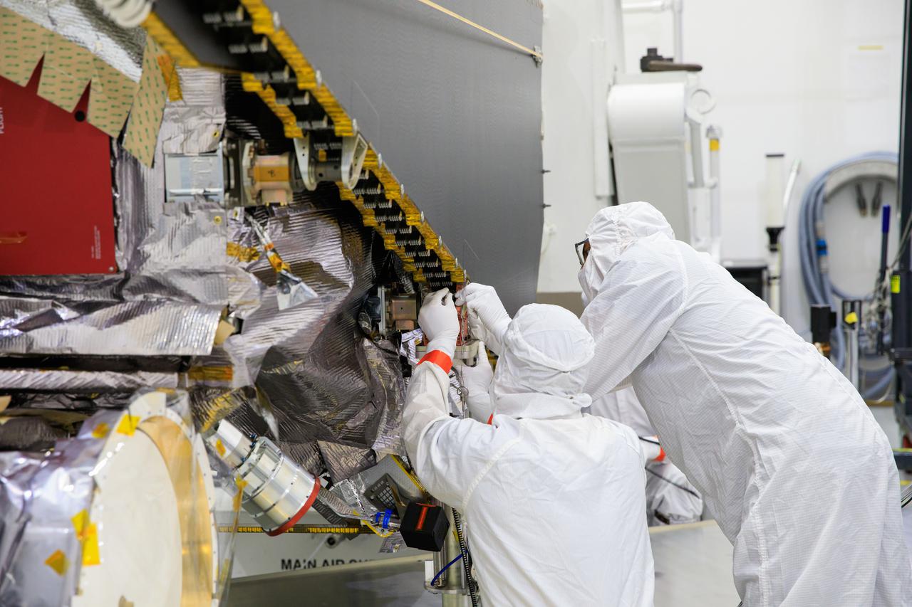 Workers inside the Astrotech Space Operations Facility in Titusville, Florida, begin to extend one of the solar arrays on NASA’s Lucy spacecraft on Aug. 19, 2021. Both solar arrays will be opened to make sure they operate correctly. Lucy is scheduled to launch no earlier than Saturday, Oct. 16, on a United Launch Alliance Atlas V 401 rocket from Space Launch Complex 41 at Cape Canaveral Space Force Station. NASA’s Launch Services Program based at Kennedy Space Center is managing the launch. Over its 12-year primary mission, Lucy will explore a record-breaking number of asteroids, flying by one asteroid in the solar system’s main belt and seven Trojan asteroids. Additionally, Lucy’s path will circle back to Earth three times for gravity assists, making it the first spacecraft ever to return to the vicinity of Earth from the outer solar system.