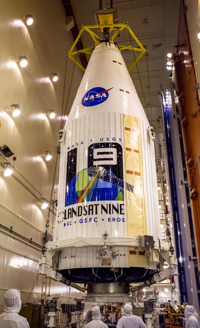 Inside the Integrated Processing Facility at Vandenberg Space Force Base in California, the Landsat 9 spacecraft, secured in the United Launch Alliance (ULA) payload fairing, is moved by crane toward the transfer tower for closeout operations on Aug. 19, 2021. Landsat 9 will launch on a ULA Atlas V rocket from Space Launch Complex 3 at Vandenberg in September 2021. The launch is being managed by NASA’s Launch Services Program based at Kennedy Space Center, America’s multi-user spaceport. The Landsat 9 satellite will continue the nearly 50-year legacy of previous Landsat missions. It will monitor key natural and economic resources from orbit. Landsat 9 is managed by the agency’s Goddard Space Flight Center in Greenbelt, Maryland. The satellite will carry two instruments: the Operational Land Imager 2, which collects images of Earth’s landscapes in visible, near infrared and shortwave infrared light, and the Thermal Infrared Sensor 2, which measures the temperature of land surfaces. Like its predecessors, Landsat 9 is a joint mission between NASA and the U.S. Geological Survey.