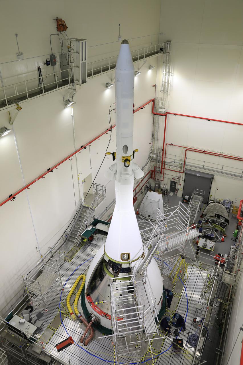 Technicians and engineers with Exploration Ground Systems and Jacobs connect the second ogive fairing for Orion’s Artemis I mission to the launch abort system (LAS) inside the Launch Abort System Facility high bay at NASA’s Kennedy Space Center in Florida on Aug. 23, 2021. The ogives consist of four protective panels that will shield the crew module from the severe vibrations and sounds it will experience during launch. During Artemis missions, the 44-foot-tall LAS will detach from the spacecraft when it is no longer needed. Launching in 2021, Artemis I will be an uncrewed test of the Orion spacecraft and Space Launch System rocket as an integrated system ahead of crewed flights to the Moon. Under Artemis, NASA aims to land the first woman and first person of color on the Moon and establish sustainable lunar exploration.