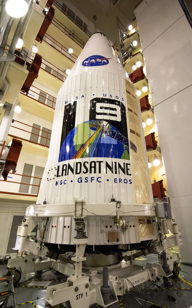 Encapsulated within the United Launch Alliance (ULA) payload fairing, the Landsat 9 spacecraft undergoes final preparations before launch inside the Integrated Processing Facility at Vandenberg Space Force Base in California on Aug. 25, 2021. Landsat 9 will launch on a ULA Atlas V rocket from Space Launch Complex 3 at Vandenberg in September 2021. The launch is being managed by NASA’s Launch Services Program based at Kennedy Space Center, America’s multi-user spaceport. The Landsat 9 satellite will continue the nearly 50-year legacy of previous Landsat missions and monitor key natural and economic resources from orbit. Landsat 9 is managed by the agency’s Goddard Space Flight Center in Greenbelt, Maryland. The satellite will carry two instruments: the Operational Land Imager 2, which collects images of Earth’s landscapes in visible, near infrared and shortwave infrared light, and the Thermal Infrared Sensor 2, which measures the temperature of land surfaces. Like its predecessors, Landsat 9 is a joint mission between NASA and the U.S. Geological Survey. 