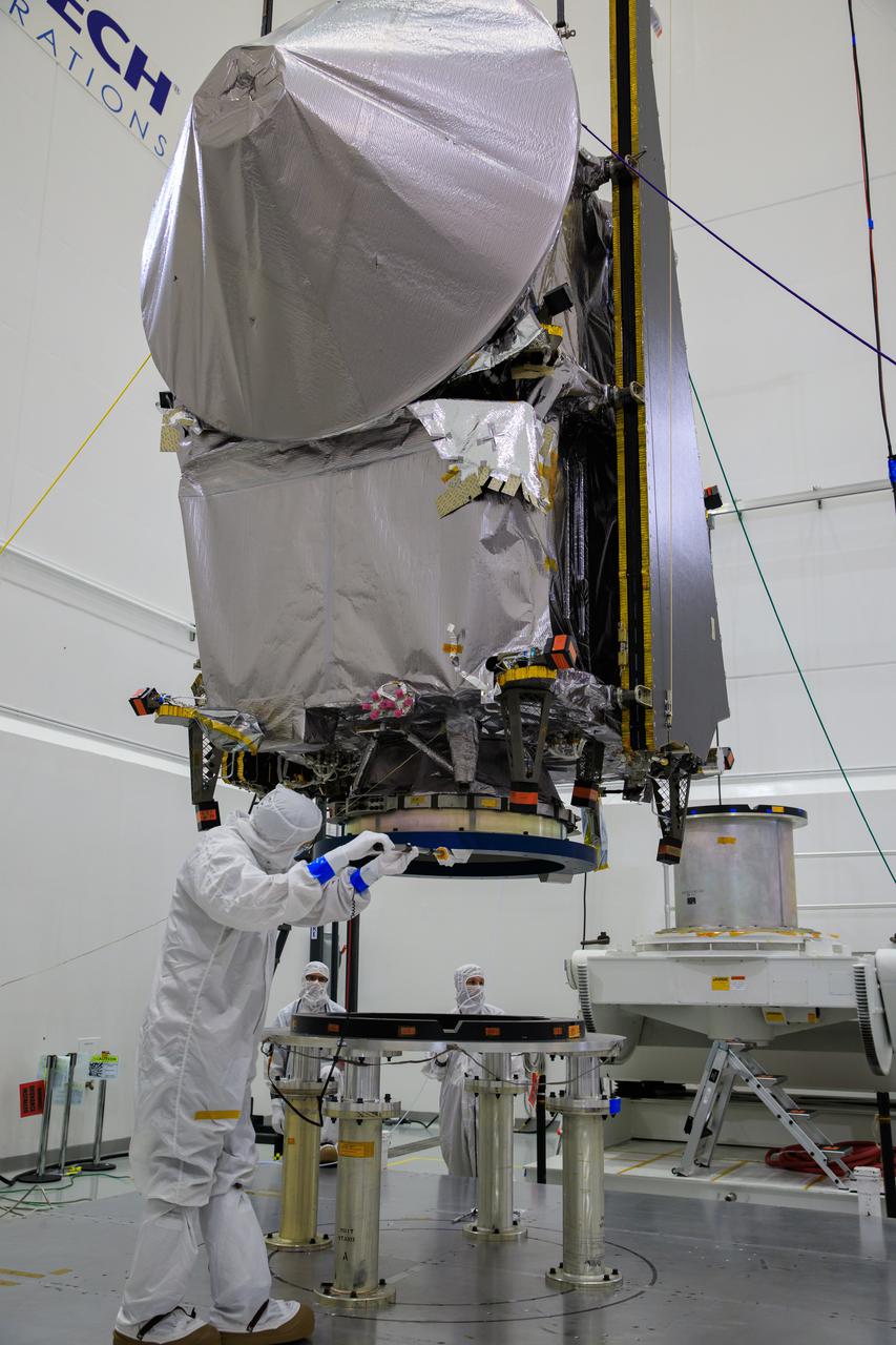 NASA’s Lucy spacecraft, with its high gain antenna attached, is lowered onto a stationary work stand inside the Astrotech Space Operations Facility in Titusville, Florida on Sept. 8, 2021. Lucy is scheduled to launch no earlier than Saturday, Oct. 16, on a United Launch Alliance Atlas V 401 rocket from Launch Pad 41 at Cape Canaveral Space Force Station. NASA’s Launch Services Program based at Kennedy Space Center is managing the launch. Over its 12-year primary mission, Lucy will explore a record-breaking number of asteroids, flying by one asteroid in the solar system’s main belt and seven Trojan asteroids. Additionally, Lucy’s path will circle back to Earth three times for gravity assists, making it the first spacecraft ever to return to the vicinity of Earth from the outer solar system.