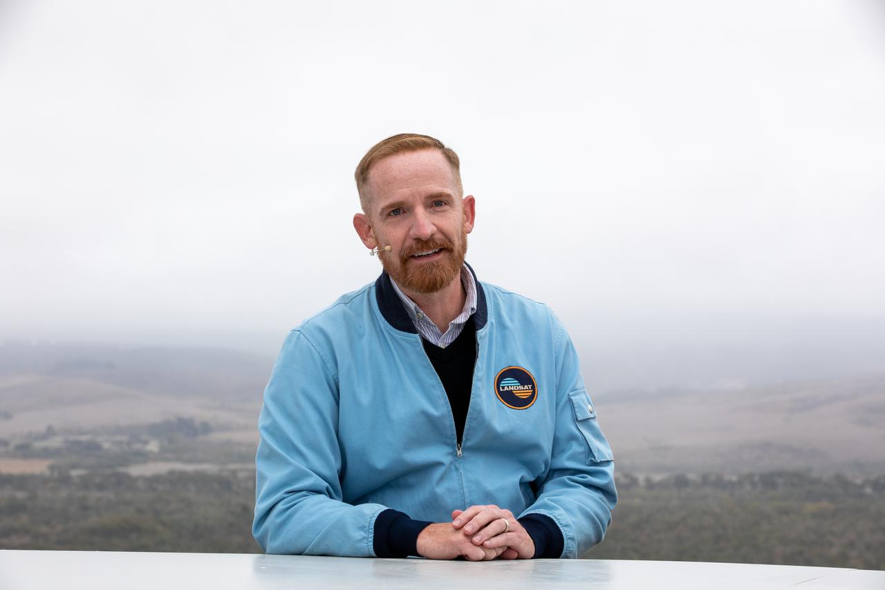 Marc Evan Jackson, actor, "Landsat Steve" in Kong: Skull Island, participates in the launch broadcast for the Landsat 9 mission on Sept. 27, 2021, at Vandenberg Space Force Base in California. NASA’s Landsat 9 satellite launched on a United Launch Alliance Atlas V 401 rocket from Vandenberg's Space Launch Complex 3 at 2:12 p.m. EDT (11:12 a.m. PDT). The launch is managed by NASA’s Launch Services Program, based at the agency’s Kennedy Space Center in Florida. Landsat 9 will join its sister satellite, Landsat 8, in orbit in collecting images from across the planet every eight days. This calibrated data will continue the Landsat program’s critical role in monitoring the health of Earth and helping people manage essential resources, including crops, irrigation water, and forests. NASA Goddard manages the Landsat 9 mission. Goddard teams also built and tested one of the two instruments on Landsat 9, the Thermal Infrared Sensor 2 (TIRS-2) instrument. TIRS-2 will use thermal imaging to make measurements that can be used to estimate soil moisture and detect the health of plants.