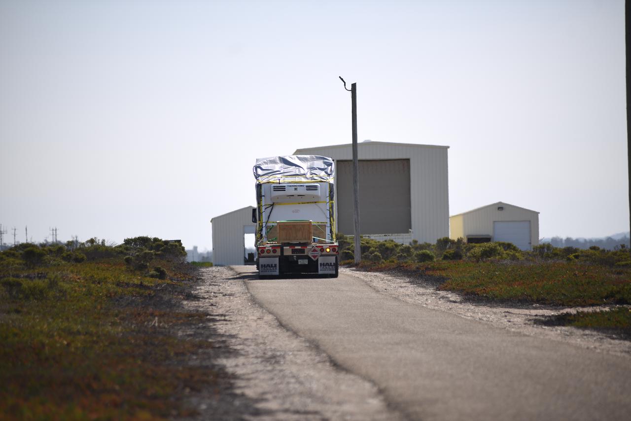 NASA’s Double Asteroid Redirection Test (DART) spacecraft, packed in its shipping container, arrives by truck at Vandenberg Space Force Base in California on Oct. 2, 2021. DART will be transported to the Astrotech Space Operations Facility where workers will put the spacecraft through a series of final tests and checkouts to confirm it is ready for launch. DART is the first mission to test technologies for preventing an impact of Earth by a hazardous asteroid. The mission is targeted to launch on Nov. 23, 2021, aboard a SpaceX Falcon 9 rocket from Vandenberg. NASA’s Launch Services Program, based at Kennedy Space Center, America’s multi-user spaceport, is managing the launch. 