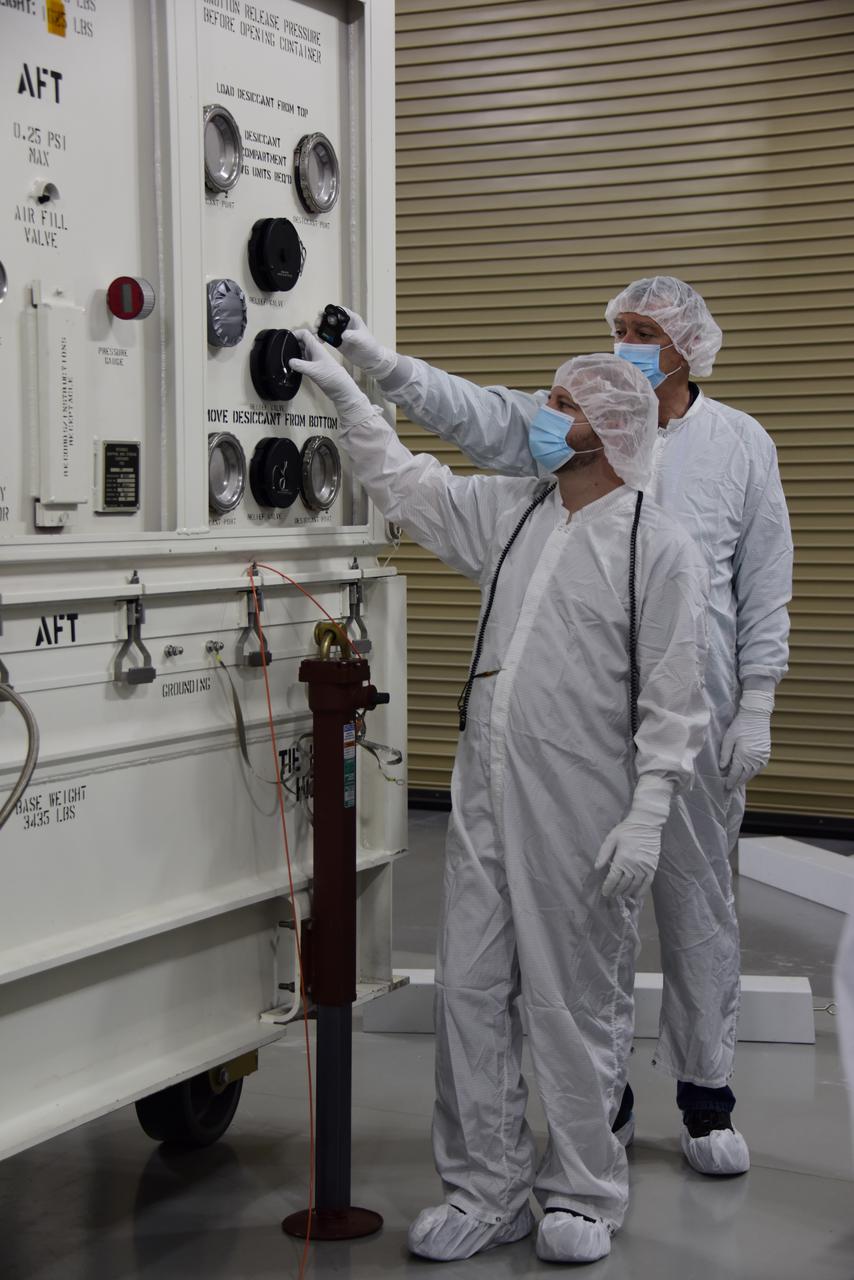 The DART spacecraft is removed from the shipping container and moved to the spacecraft dolly inside Astrotech at Vandenberg Space Force Base in California.