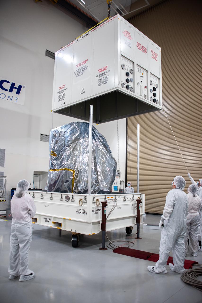 Technicians remove NASA’s Double Asteroid Redirection Test (DART) spacecraft from its shipping container inside the Astrotech Space Operations Facility at Vandenberg Space Force Base in California on Oct. 4, 2021. Once fully unpacked, the spacecraft will undergo a series of tests and checkouts to confirm it is ready for launch. DART is the first mission to test technologies for preventing an impact of Earth by a hazardous asteroid. The mission is targeted to launch on Nov. 23, 2021, aboard a SpaceX Falcon 9 rocket from Vandenberg. NASA’s Launch Services Program, based at Kennedy Space Center, America’s multi-user spaceport, is managing the launch.