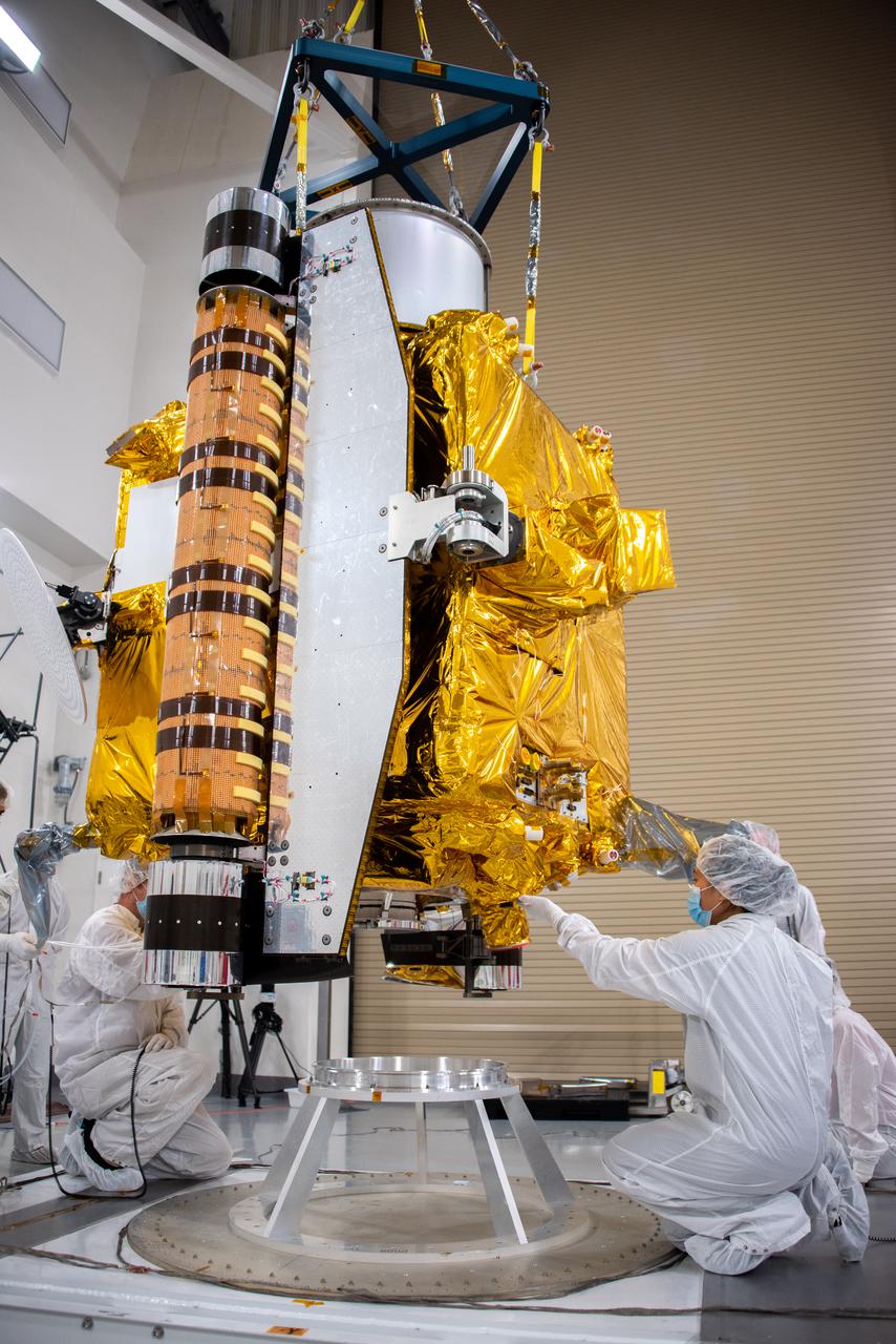 Technicians lower NASA’s Double Asteroid Redirection Test (DART) spacecraft onto a work stand inside the Astrotech Space Operations Facility at Vandenberg Space Force Base in California on Oct. 4, 2021. Once secured on its stand, the spacecraft will undergo a series of tests and checkouts to confirm it is ready for launch. DART is the first mission to test technologies for preventing an impact of Earth by a hazardous asteroid. The mission is targeted to launch on Nov. 23, 2021, aboard a SpaceX Falcon 9 rocket from Vandenberg. NASA’s Launch Services Program, based at Kennedy Space Center, America’s multi-user spaceport, is managing the launch.