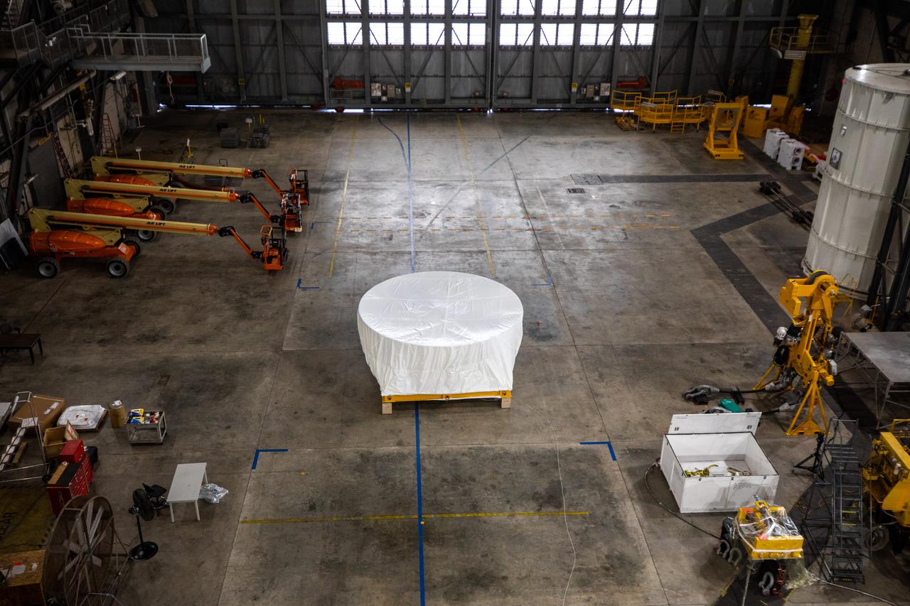 Under a protective cover, the Orion Stage Adapter (OSA) arrives in High Bay 4 of the Vehicle Assembly Building on Oct. 4, 2021, at NASA's Kennedy Space Center in Florida. Teams will lift the ring-shaped OSA, filled with shoebox-sized CubeSats, and connect it to the Interim Cryogenic Propulsion Stage (ICPS). The Orion spacecraft will be secured on top of the Space Launch System (SLS) rocket to complete the stack ahead of the Artemis I launch. This mission will be the first integrated flight test of the SLS and Orion spacecraft. In later missions, NASA will land the first woman and the first person of color on the surface of the Moon, paving the way for a long-term lunar presence and serving as a steppingstone on the way to Mars.