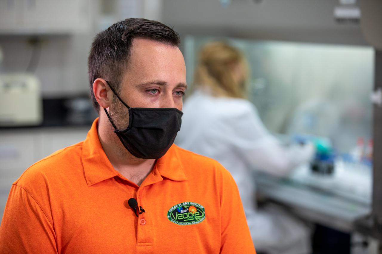 Inside the Microbiology Lab at NASA’s Kennedy Space Center in Florida on Oct. 6, 2021, Microbiologist Aaron Curry works with frozen lettuce samples that recently returned from the International Space Station as part of NASA’s SpaceX 23rd commercial resupply services mission. The experiment, titled VEG-03J, involved “Outredgeous” red romaine lettuce grown in the Veggie Production System (Veggie) on the space station and demonstrated a new way of storing, handling, and planting seeds in space. NASA is studying how to effectively grow crops in space so plants can provide supplemental nutrients to astronaut crews on long-duration missions, such as a mission to Mars.