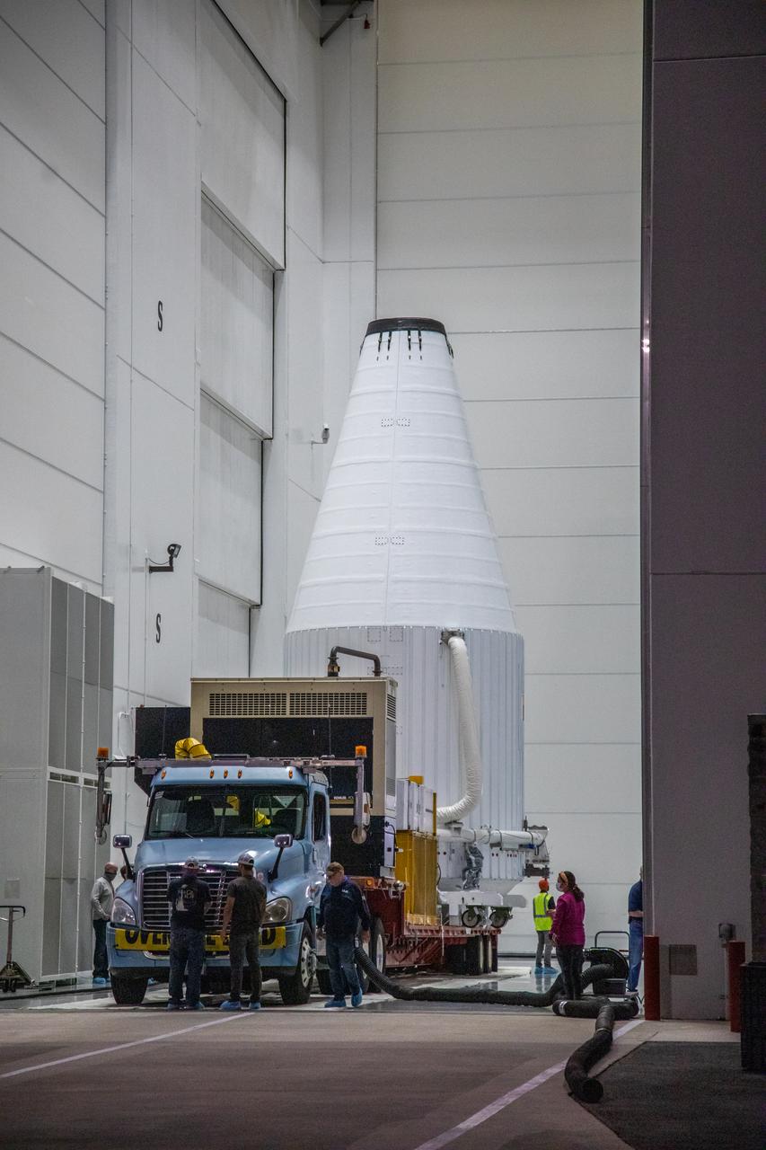 The Lucy spacecraft, encapsulated in its payload fairing, exits the Astrotech Space Operations Facility in Titusville, Florida on Oct. 7, 2021. The spacecraft will be transported to nearby Space Launch Complex 41 at Cape Canaveral Space Force Station. The encapsulated spacecraft will be hoisted up and into the Vertical Integration Facility where it will be lowered down and secured on the United Launch Alliance (ULA) Atlas V Centaur second stage.  Lucy is scheduled to launch no earlier than Saturday, Oct. 16, on the ULA Atlas V 401 rocket from Launch Pad 41. NASA’s Launch Services Program, based at Kennedy Space Center, America’s premier multi-user spaceport, is managing the launch. Over its 12-year primary mission, Lucy will explore a record-breaking number of asteroids, flying by one asteroid in the solar system’s main belt and seven Trojan asteroids. Additionally, Lucy’s path will circle back to Earth three times for gravity assists, making it the first spacecraft ever to return to the vicinity of Earth from the outer solar system.