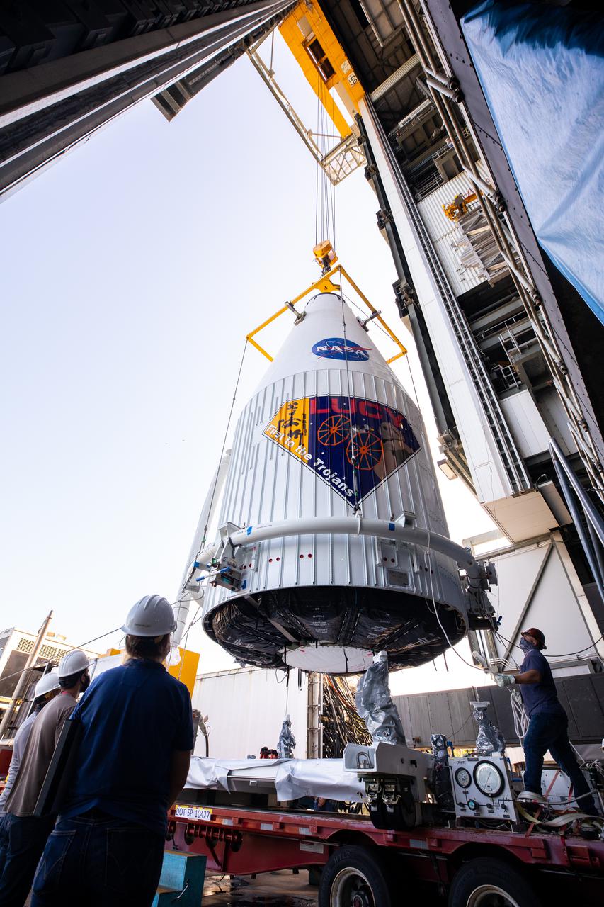 The payload fairing containing NASA’s Lucy spacecraft is hoisted up at the Vertical Integration Facility at Space Launch Complex 41 at Cape Canaveral Space Force Station in Florida on Oct. 7, 2021. It will be lowered onto the United Launch Alliance (ULA) Atlas V Centaur second stage. Lucy is scheduled to launch no earlier than Saturday, Oct. 16, on the ULA Atlas V 401 rocket from Launch Pad 41. NASA’s Launch Services Program, based at Kennedy Space Center, America’s premier multi-user spaceport, is managing the launch. Over its 12-year primary mission, Lucy will explore a record-breaking number of asteroids, flying by one asteroid in the solar system’s main belt and seven Trojan asteroids. Additionally, Lucy’s path will circle back to Earth three times for gravity assists, making it the first spacecraft ever to return to the vicinity of Earth from the outer solar system.