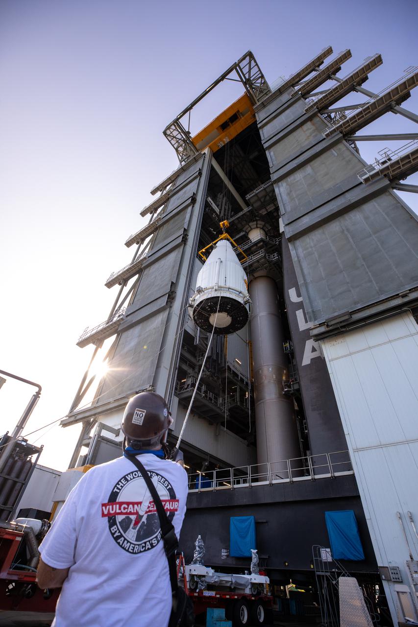 The payload fairing containing NASA’s Lucy spacecraft is hoisted up at the Vertical Integration Facility at Space Launch Complex 41 at Cape Canaveral Space Force Station in Florida on Oct. 7, 2021. It will be lowered onto the United Launch Alliance (ULA) Atlas V Centaur second stage. Lucy is scheduled to launch no earlier than Saturday, Oct. 16, on the ULA Atlas V 401 rocket from Launch Pad 41. NASA’s Launch Services Program, based at Kennedy Space Center, America’s premier multi-user spaceport, is managing the launch. Over its 12-year primary mission, Lucy will explore a record-breaking number of asteroids, flying by one asteroid in the solar system’s main belt and seven Trojan asteroids. Additionally, Lucy’s path will circle back to Earth three times for gravity assists, making it the first spacecraft ever to return to the vicinity of Earth from the outer solar system.