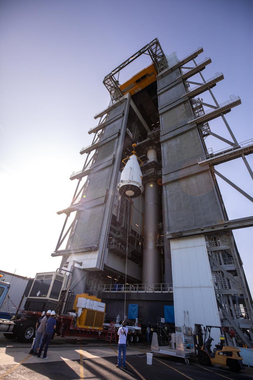 The payload fairing containing NASA’s Lucy spacecraft is hoisted up at the Vertical Integration Facility at Space Launch Complex 41 at Cape Canaveral Space Force Station in Florida on Oct. 7, 2021. It will be lowered onto the United Launch Alliance (ULA) Atlas V Centaur second stage. Lucy is scheduled to launch no earlier than Saturday, Oct. 16, on the ULA Atlas V 401 rocket from Launch Pad 41. NASA’s Launch Services Program, based at Kennedy Space Center, America’s premier multi-user spaceport, is managing the launch. Over its 12-year primary mission, Lucy will explore a record-breaking number of asteroids, flying by one asteroid in the solar system’s main belt and seven Trojan asteroids. Additionally, Lucy’s path will circle back to Earth three times for gravity assists, making it the first spacecraft ever to return to the vicinity of Earth from the outer solar system.
