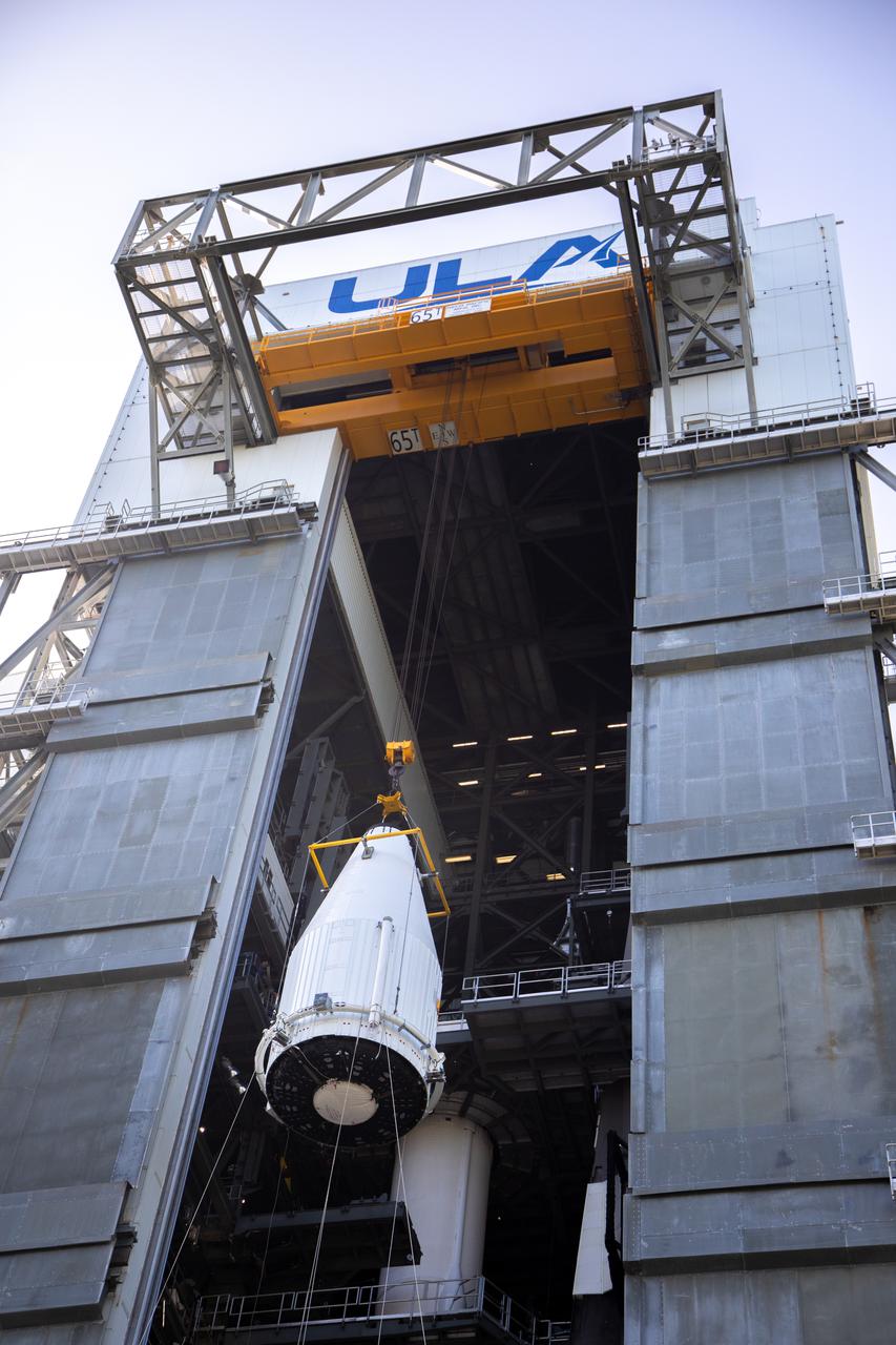 The payload fairing containing NASA’s Lucy spacecraft is hoisted up at the Vertical Integration Facility at Space Launch Complex 41 at Cape Canaveral Space Force Station in Florida on Oct. 7, 2021. It will be lowered onto the United Launch Alliance (ULA) Atlas V Centaur second stage. Lucy is scheduled to launch no earlier than Saturday, Oct. 16, on the ULA Atlas V 401 rocket from Launch Pad 41. NASA’s Launch Services Program, based at Kennedy Space Center, America’s premier multi-user spaceport, is managing the launch. Over its 12-year primary mission, Lucy will explore a record-breaking number of asteroids, flying by one asteroid in the solar system’s main belt and seven Trojan asteroids. Additionally, Lucy’s path will circle back to Earth three times for gravity assists, making it the first spacecraft ever to return to the vicinity of Earth from the outer solar system.