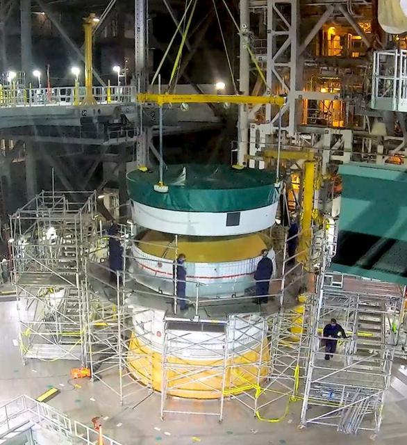 Inside NASA’s iconic Vehicle Assembly Building at Kennedy Space Center in Florida, teams from Exploration Ground Systems and contractor Jacobs mate the Orion Stage Adapter (OSA) to the interim cryogenic propulsion stage (ICPS) on top of the Space Launch System (SLS) on Oct. 9, 2021. The addition of the OSA marks the last piece of SLS rocket hardware to be added before crews soon add the Orion spacecraft and its launch abort system on top of the OSA. The ring-shaped OSA is filled with 10 shoebox-sized CubeSats that will deploy when the ICPS separates from Orion on its way to the Moon during Artemis I, which will be the first integrated flight test of the SLS and Orion spacecraft. In later missions, NASA will land the first woman and the first person of color on the surface of the Moon, paving the way for a long-term lunar presence and serving as a steppingstone on the way to Mars.