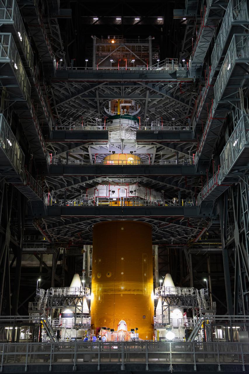 Inside NASA’s iconic Vehicle Assembly Building at Kennedy Space Center in Florida, teams from Exploration Ground Systems and contractor Jacobs mate the Orion Stage Adapter (OSA) to the Interim Cryogenic Propulsion Stage (ICPS) on top of the Space Launch System (SLS) on Oct. 9, 2021. The addition of the OSA marks the last piece of SLS rocket hardware to be added before crews soon add the Orion spacecraft and its launch abort system on top of the OSA. The ring-shaped OSA is filled with 10 shoebox-sized CubeSats that will deploy when the ICPS separates from Orion on its way to the Moon during Artemis I, which will be the first integrated flight test of the SLS and Orion spacecraft. In later missions, NASA will land the first woman and the first person of color on the surface of the Moon, paving the way for a long-term lunar presence and serving as a steppingstone on the way to Mars. 